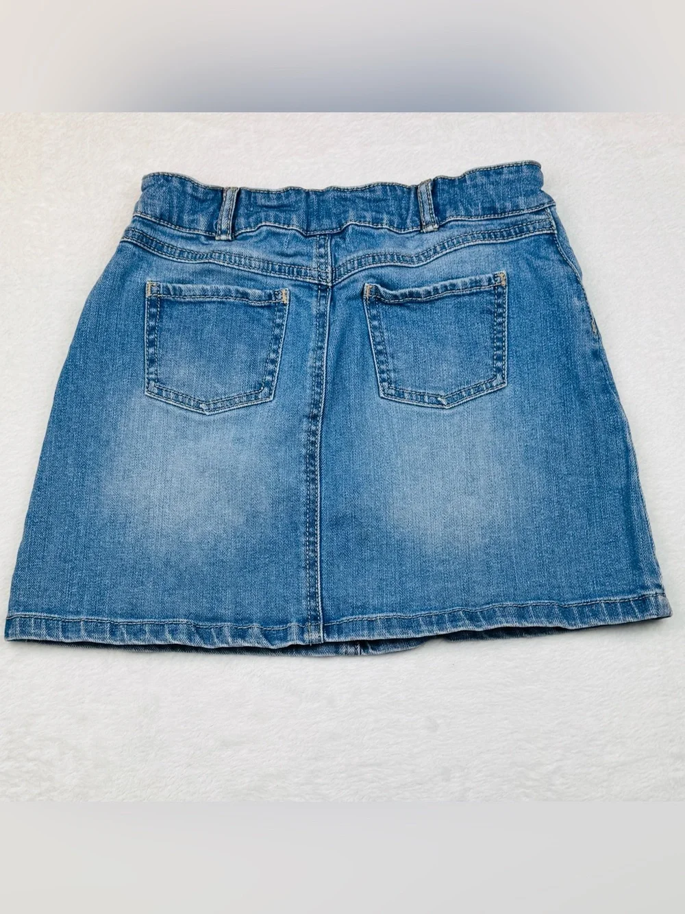 Lot of 2 girls denim skirts. The blue shirt is a size 8, black skirt is size 7/8